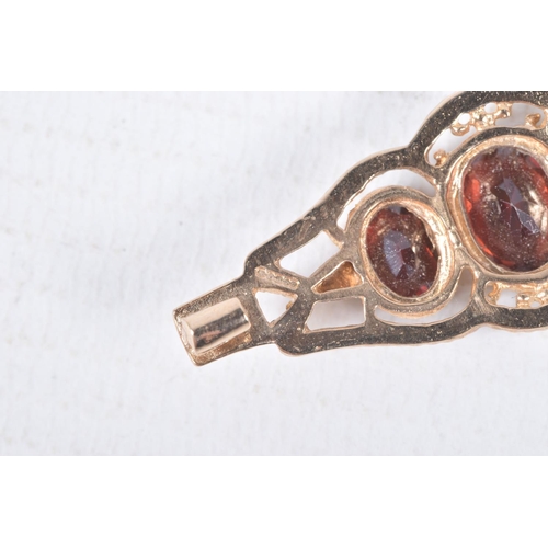 97 - A 9CT GOLD RING AND YELLOW METAL BROOCH, an oval cut garnet, prong set in yellow gold leading on to ... 