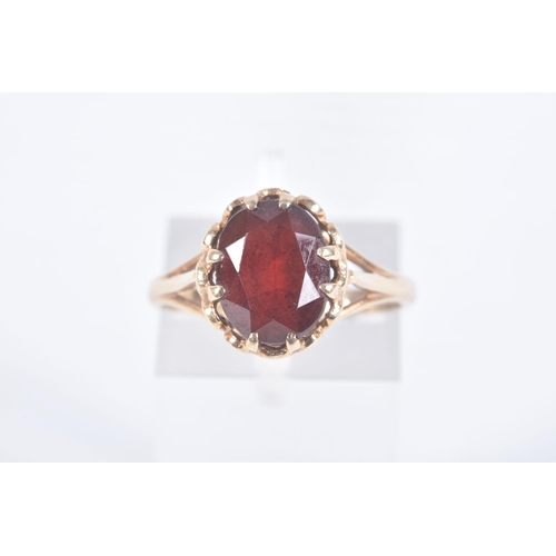 97 - A 9CT GOLD RING AND YELLOW METAL BROOCH, an oval cut garnet, prong set in yellow gold leading on to ... 