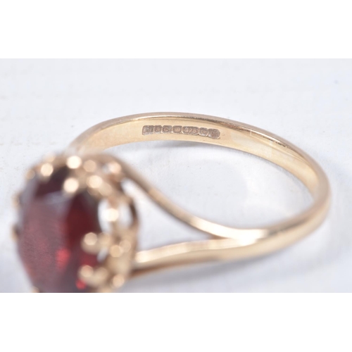 97 - A 9CT GOLD RING AND YELLOW METAL BROOCH, an oval cut garnet, prong set in yellow gold leading on to ... 