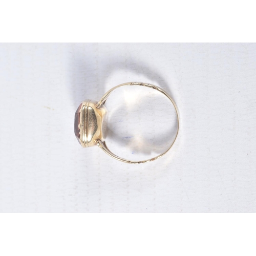 99 - A MID VICTORIAN PASTE RING, the rectangular orange paste in a closed back setting, to the trifurcate... 