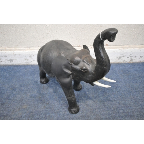 1201 - IN THE MANNER OF LIBERTY OF LONDON, A SMALL LEATHER FIGURE OF A BELLOWING ELEPHANT, height 48cm (con... 