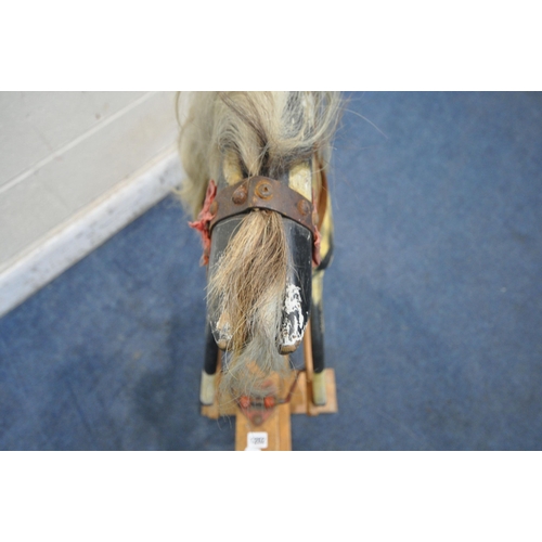 1202 - AN EARLY 20TH CENTURY PLAYWORN DAPPLED CHILDS ROCKING HORSE, with leatherette and upholstered saddle... 