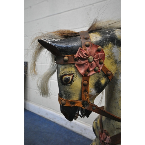 1202 - AN EARLY 20TH CENTURY PLAYWORN DAPPLED CHILDS ROCKING HORSE, with leatherette and upholstered saddle... 