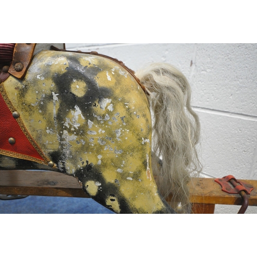 1202 - AN EARLY 20TH CENTURY PLAYWORN DAPPLED CHILDS ROCKING HORSE, with leatherette and upholstered saddle... 