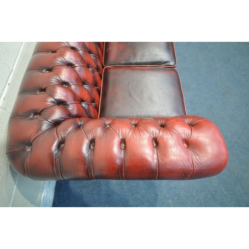 1204 - AN OXBLOOD LEATHER CHESTERFIELD BUTTONED THREE SEATER SOFA, length 200cm x depth 90cm x height 68cm ... 