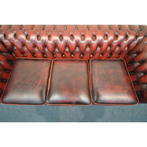 1204 - AN OXBLOOD LEATHER CHESTERFIELD BUTTONED THREE SEATER SOFA, length 200cm x depth 90cm x height 68cm ... 