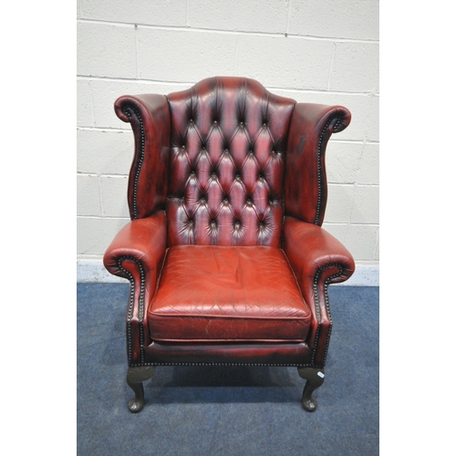 1206 - AN OXBLOOD LEATHER CHESTERFIELD WING BACK ARMCHAIR, on front cabriole legs, width 81cm x depth 84cm ... 