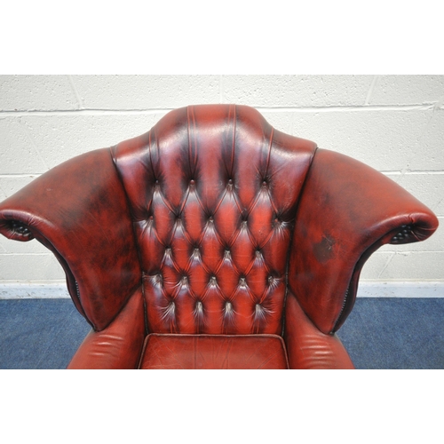 1206 - AN OXBLOOD LEATHER CHESTERFIELD WING BACK ARMCHAIR, on front cabriole legs, width 81cm x depth 84cm ... 