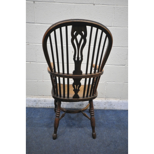 1217 - A 19TH CENTURY ELM AND BEECH WINDSOR ELBOW CHAIR, with spindle back and central splat, on turned sup... 