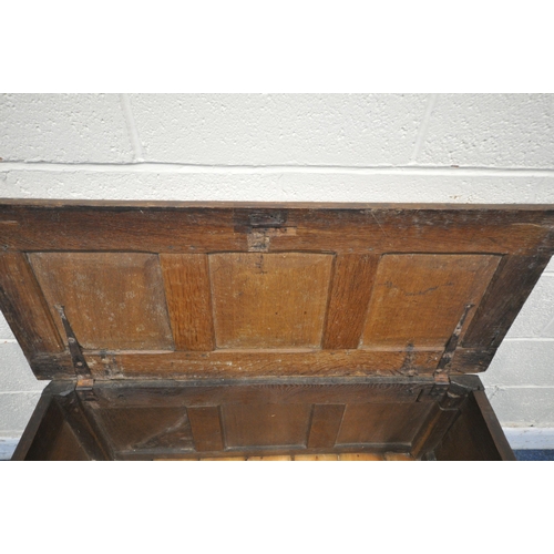 1218 - A GEORGIAN OAK COFFER, with a hinged lid, the front panels with scrolled and foliate carvings, width... 