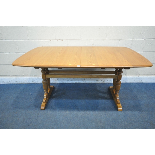 1221 - AN ERCOL ELM EXTENDING DINING TABLE, with three additional leaves, extended length 252cm closed leng... 