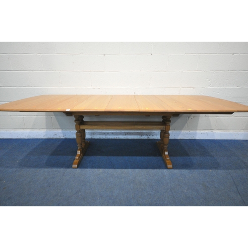 1221 - AN ERCOL ELM EXTENDING DINING TABLE, with three additional leaves, extended length 252cm closed leng... 