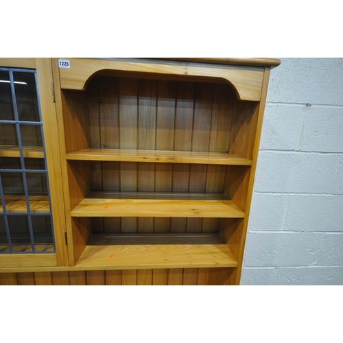 1225 - A MODERN QUALITY ASH DRESSER, fitted with an arrangement of shelving, two lead glazed doors and four... 