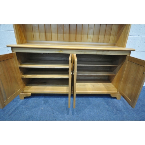 1225 - A MODERN QUALITY ASH DRESSER, fitted with an arrangement of shelving, two lead glazed doors and four... 