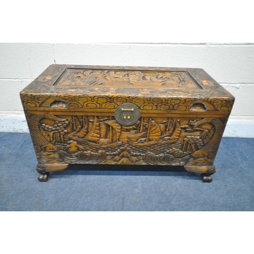 1228 - A 20TH CENTURY CAMPHORWOOD BLANKET CHEST, with detailed carving depicting ships, mountains, fish, et... 