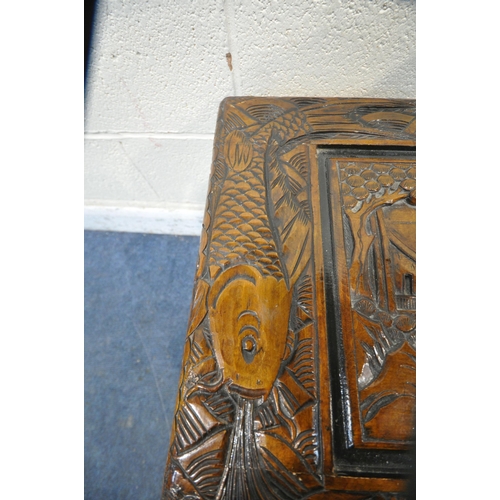 1228 - A 20TH CENTURY CAMPHORWOOD BLANKET CHEST, with detailed carving depicting ships, mountains, fish, et... 