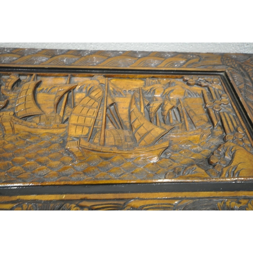 1228 - A 20TH CENTURY CAMPHORWOOD BLANKET CHEST, with detailed carving depicting ships, mountains, fish, et... 