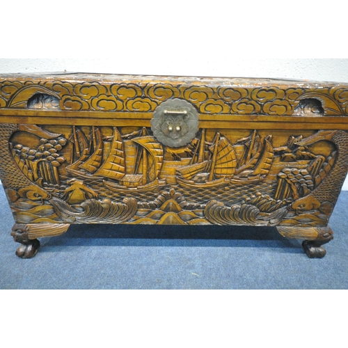 1228 - A 20TH CENTURY CAMPHORWOOD BLANKET CHEST, with detailed carving depicting ships, mountains, fish, et... 