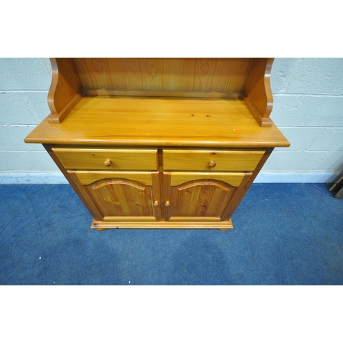 1254 - A MODERN PINE DRESSER, the domed top with two glazed doors, the base with two drawers and two cupboa... 