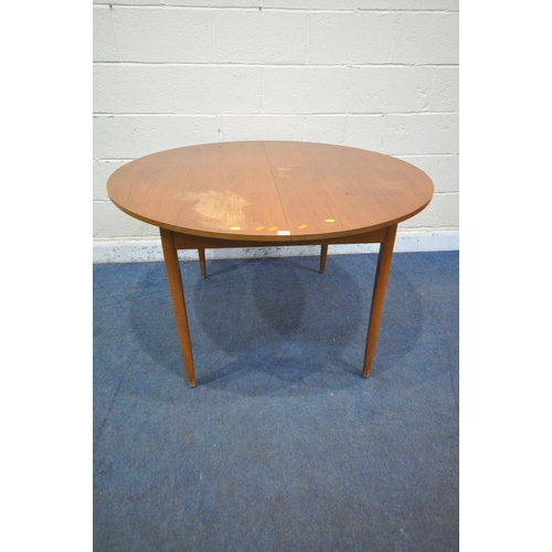 1263 - A MID CENTURY TEAK EXTENDING DINING TABLE, with a single fold out leaf, open length 181cm x diameter... 