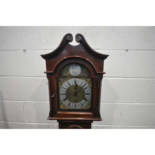 1277 - A 20TH CENTURY MAHOGANY TEMPUS FUGIT LONG CASE CLOCK, the arched dial enclosing a seven inch brass a... 