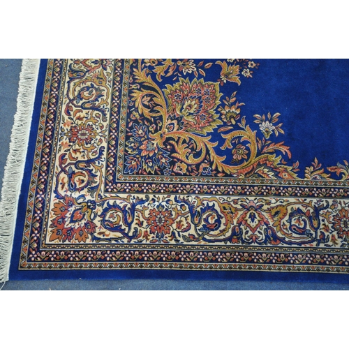 1282 - A 20TH CENTURY LOUIS DE POORTERE KANDAHAR WORSTED WOOL RUG, with a blue field, central medallion and... 