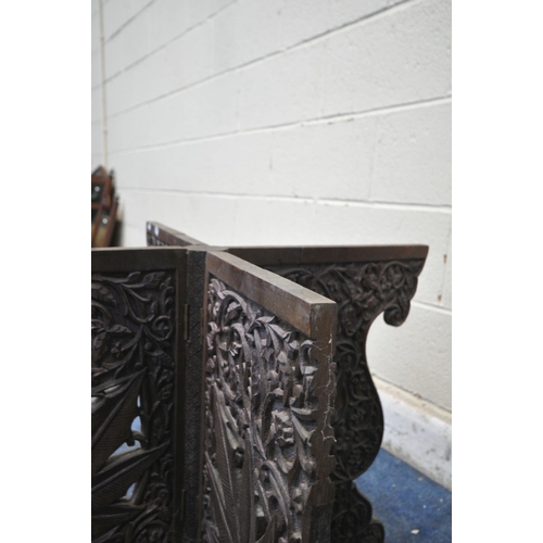 1299 - AN ANGLO INDIAN CARVED FOLDING TABLE, depicting leaves and other foliage, 79cm squared x height 59cm... 