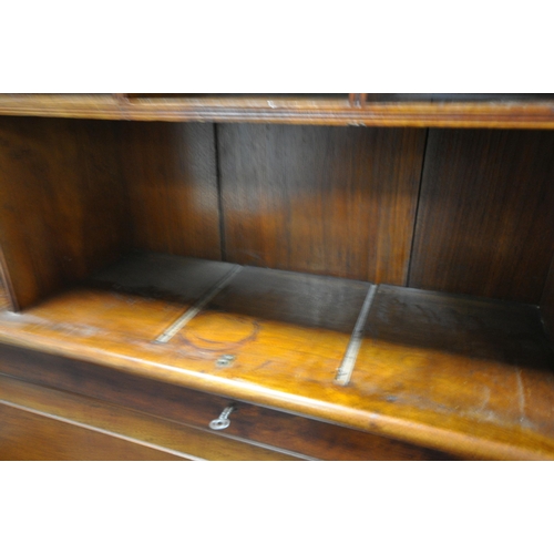 1311 - AN EARLY 20TH CENTURY WALNUT BUREAU BOOKCASE, the double bevelled glass doors enclosing an arrangeme... 