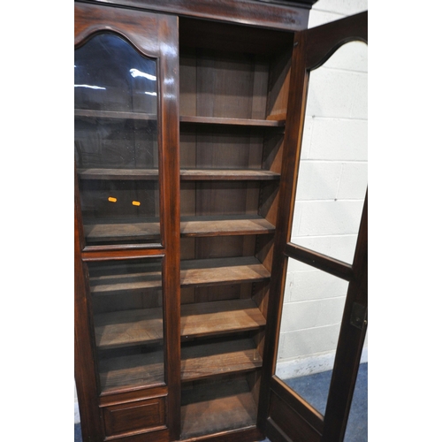 1318 - A LATE 19TH / EARLY 20TH CENTURY MAHOGANY BOOKCASE, with double glazed doors, and six adjustable she... 