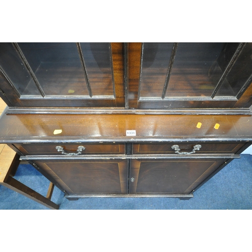 1331 - A 20TH CENTURY FLAME MAHOGANY BOOKCASE, the two glazed doors enclosing two adjustable shelves, above... 