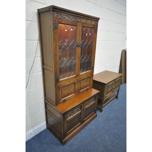 1374 - AN OLD CHARM OAK BOOKCASE, the two lead glazed doors enclosing two adjustable glass shelves, a fall ... 