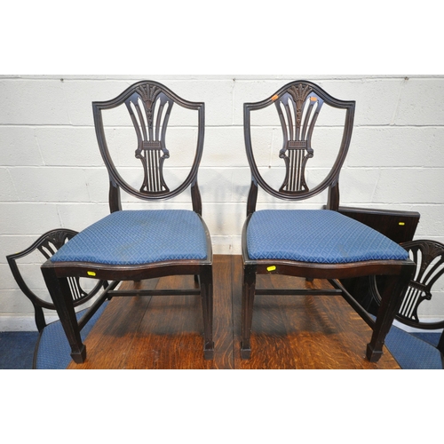 1389 - A 20TH CENTURY OAK WIND OUT DINING TABLE, with canted corners on turned legs, and an additional leaf... 