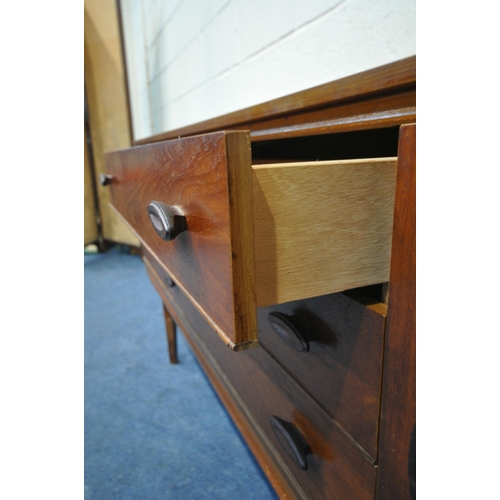 1393 - A MID CENTURY TEAK SIDEBOARD, fitted with two cupboard doors, flanking three drawers, on square tape... 