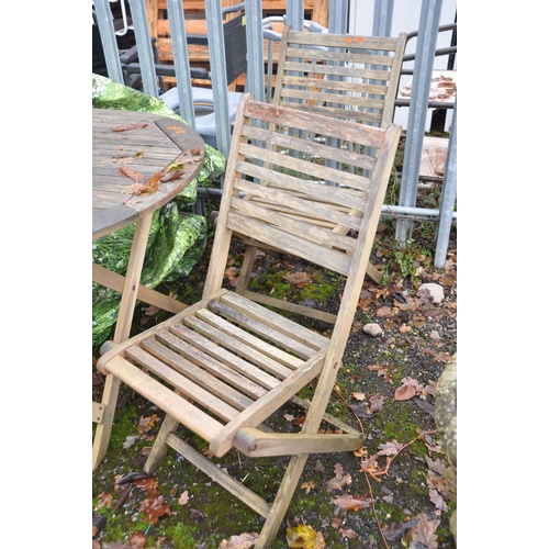 1008 - A MODERN TEAK GARDEN TABLE, 150cm long four matching folding chairs, a parasol base and a cover (7)