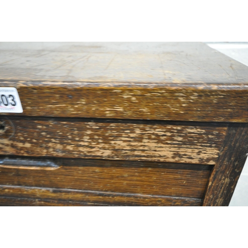 1403 - A 20TH CENTURY OAK TAMBOUR FRONT FILING CABINET, the door enclosing nine drawers, width 46cm x depth... 