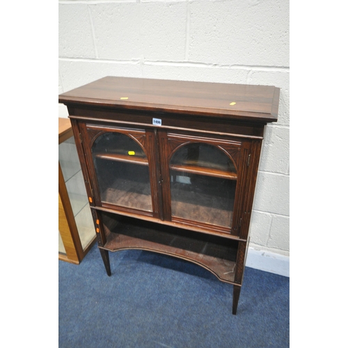 1406 - A 20TH CENTURY CABINET, the double doors with arched bevelled edge glass panes, on square tapered le... 