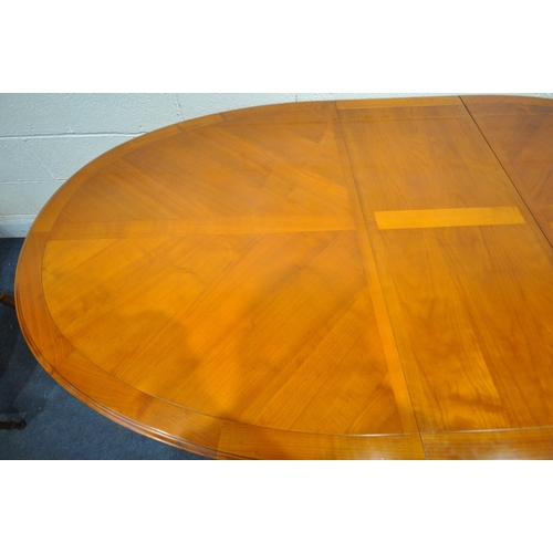 1419 - A REPRODUCTION CHERRYWOOD OVAL EXTENDING DINING TABLE, with one additional leaf, on six square taper... 