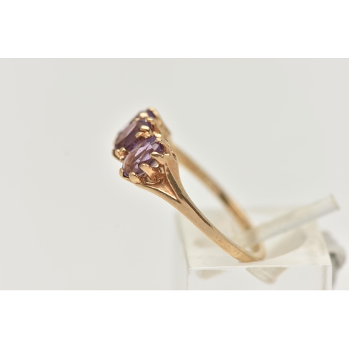 100 - A 9CT GOLD AMETHYST RING, set with three oval cut amethysts, each claw set to the bifurcated shoulde... 