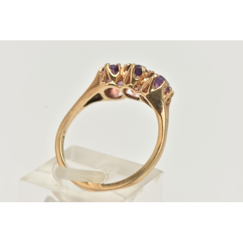 100 - A 9CT GOLD AMETHYST RING, set with three oval cut amethysts, each claw set to the bifurcated shoulde... 