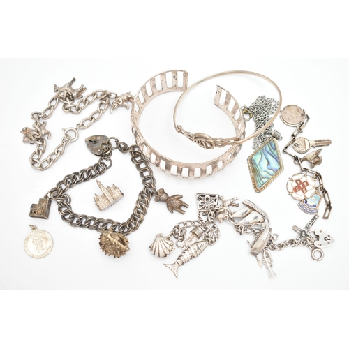 140 - A SMALL ASSORTMENT OF WHITE METAL JEWELLERY, to include a cuff bangle, three charm bracelets, a flor... 