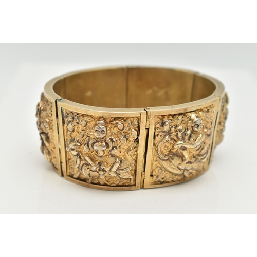 143 - A VICTORIAN GILT BRACELET, comprised of six slightly tapered panels, embossed with an Indian design,... 