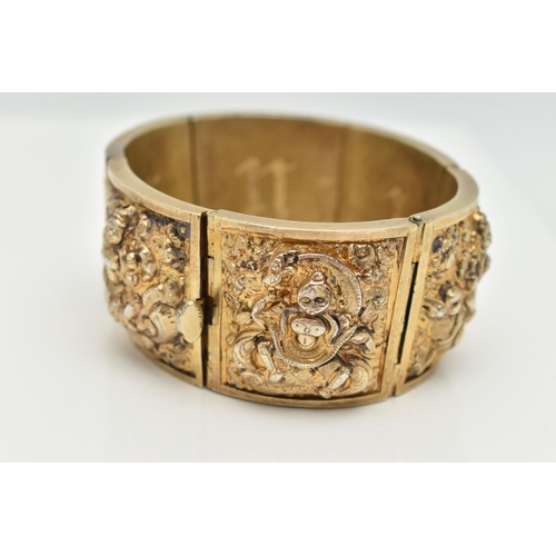 143 - A VICTORIAN GILT BRACELET, comprised of six slightly tapered panels, embossed with an Indian design,... 