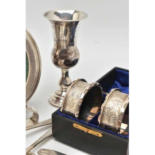 150 - A SMALL PARCEL OF SILVER, comprising a cased pair of late Victorian circular napkin rings, engraved ... 