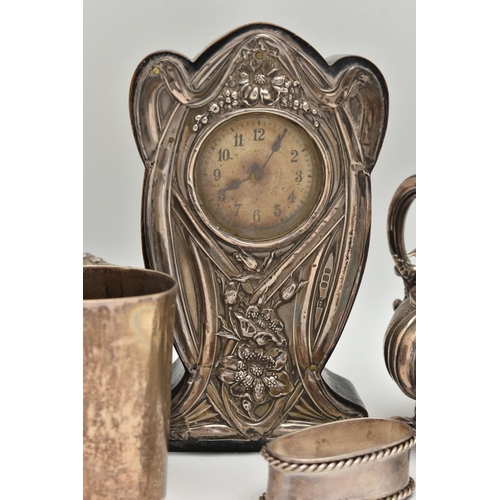 162 - A SILVER CLOCK AND ASSORTED WHITE METAL ITEMS, to include a floral art nouveau style silver fronted ... 