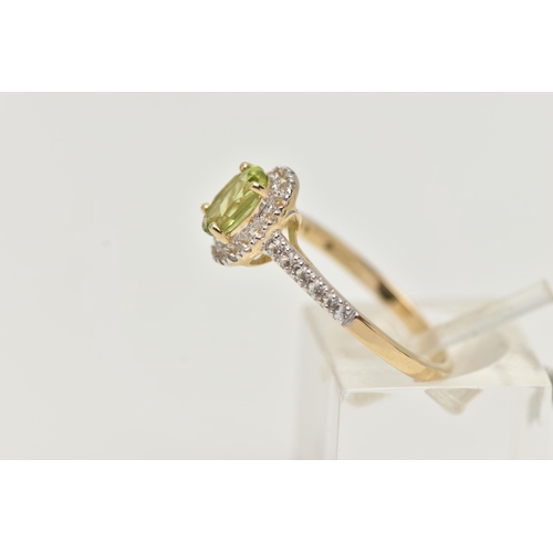 33 - A 9CT GOLD PERIDOT AND DIAMOND RING, an oval cut peridot, set with a surround of round brilliant cut... 