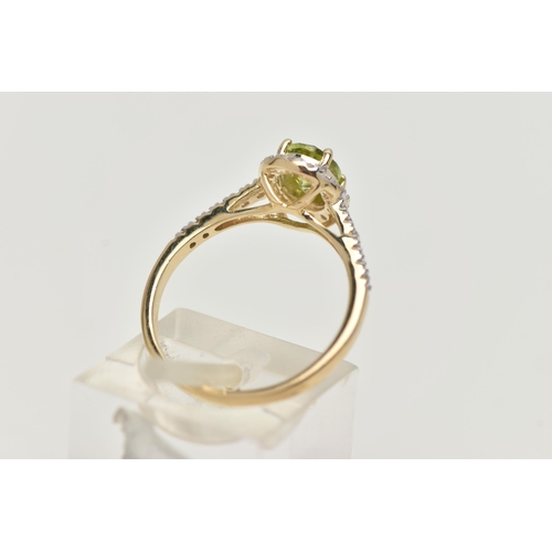 33 - A 9CT GOLD PERIDOT AND DIAMOND RING, an oval cut peridot, set with a surround of round brilliant cut... 