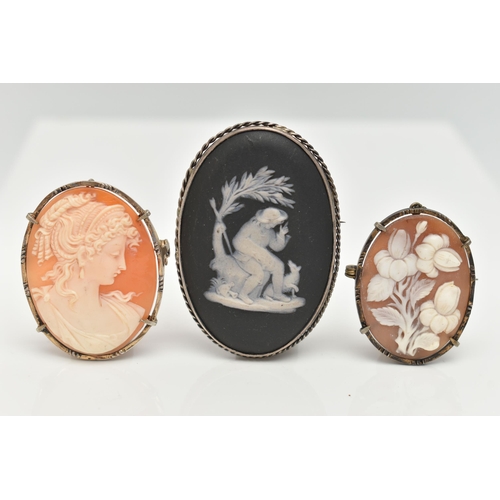 38 - THREE CAMEO BROOCHES, the first a black Wedgewood cameo set in a white metal mount, unmarked, togeth... 