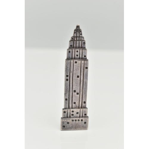 41 - A WHITE METAL BROOCH, in the form of the empire estate building, stamped to the reverse 'Woods' 925,... 
