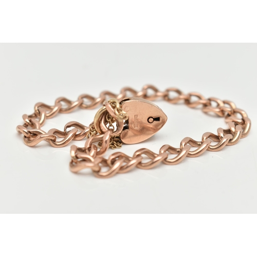 64 - A ROSE METAL CURB LINK BRACELET, solid curb links, most stamped 9.375, fitted with a yellow metal he... 