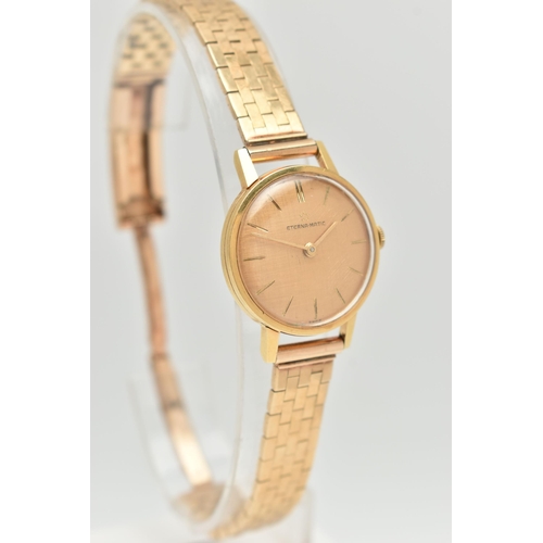 80 - A 9CT GOLD ETERNA MATIC WRISTWATCH, the textured champagne coloured dial, with gold coloured hourly ... 